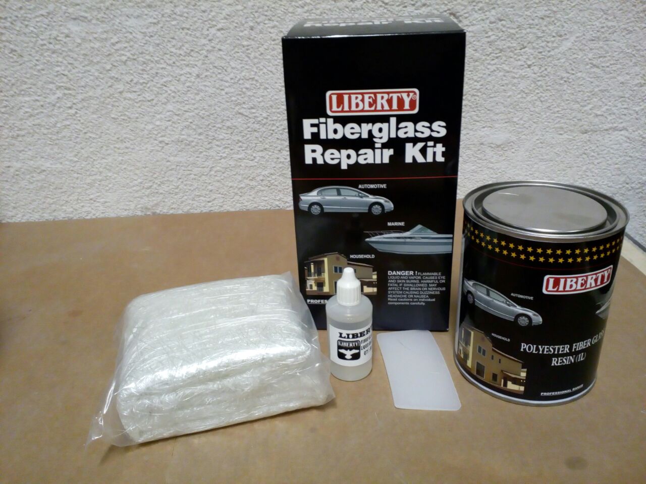 Liberty Fiberglass Repair Kit with fiberglass cloth, resin & hardener, gloves, mixing sticks, and brush – ideal for patching cracks, holes, and structural damage on boats, cars, tubs, RVs and more; includes all tools for easy fiberglass repair.

